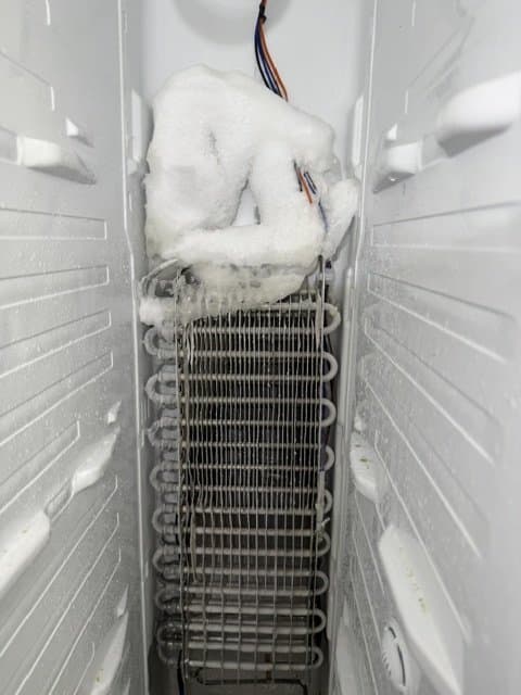 Frozen refrigerator evaporator coil during appliance service