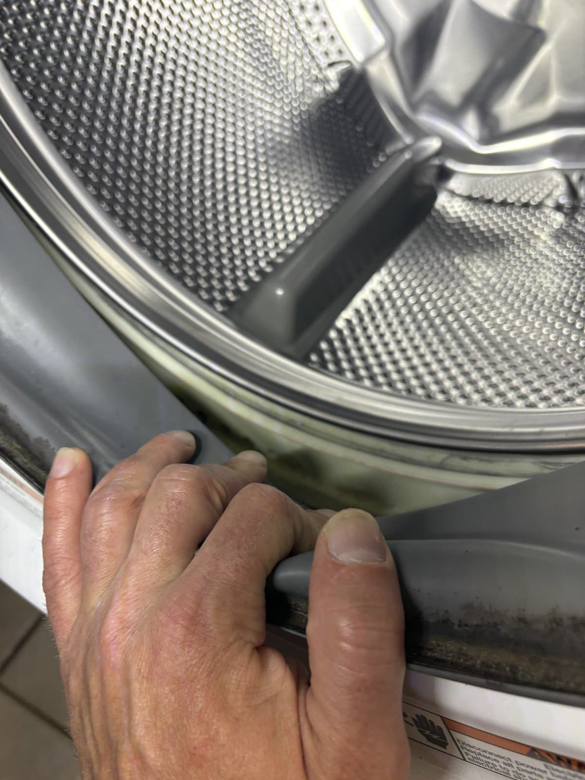 Washer door seal being inspected during appliance service